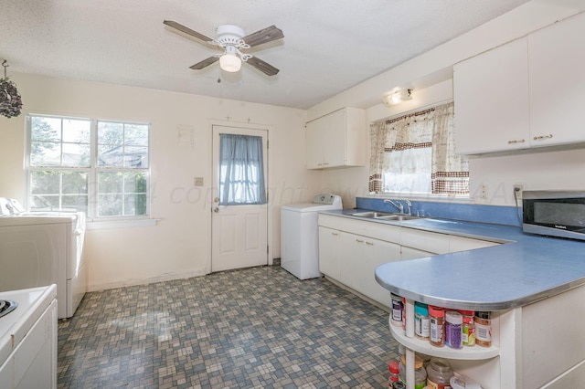 clothes washing area with a healthy amount of sunlight, sink, a textured ceiling, and ceiling fan