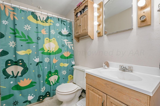 bathroom with vanity, toilet, and tile patterned flooring