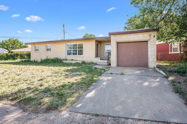 ranch-style house featuring a garage and a front lawn