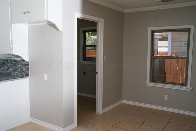 709 N Wells St, Pampa, TX 79065 - interior space featuring crown molding, a healthy amount of sunlight, and light tile patterned floors