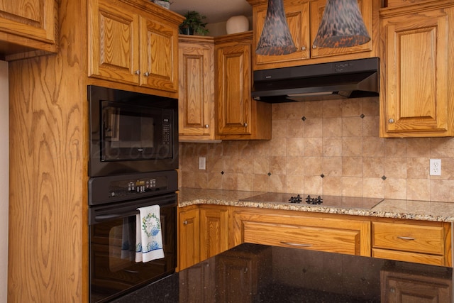 103 N Timbercreek Dr, Amarillo, TX 79118 - kitchen with under cabinet range hood, light stone counters, black appliances, and tasteful backsplash