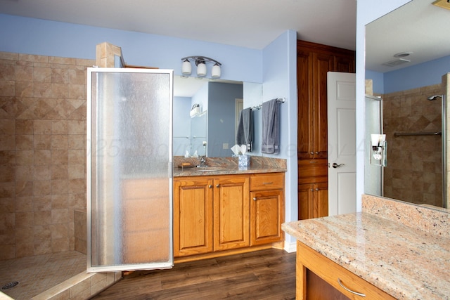 103 N Timbercreek Dr, Amarillo, TX 79118 - bathroom featuring a shower stall, vanity, and wood finished floors
