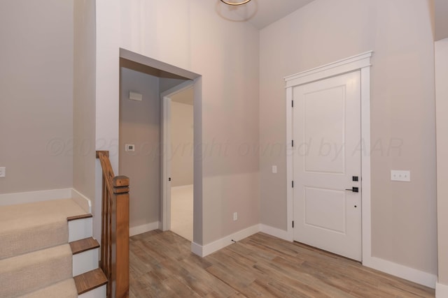 entryway with baseboards and light wood-type flooring