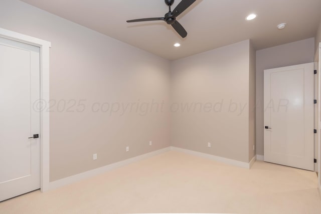 spare room featuring light colored carpet, a ceiling fan, baseboards, and recessed lighting