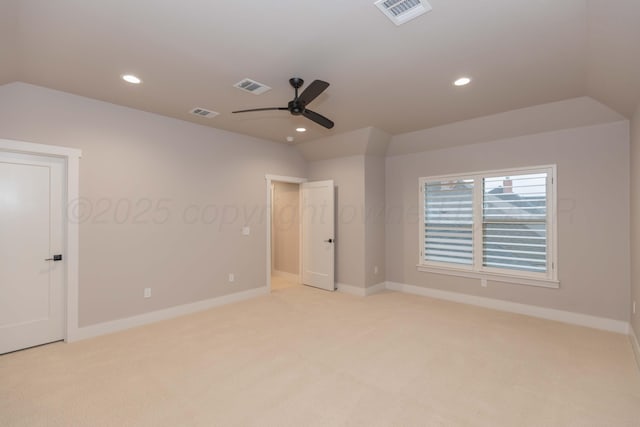 unfurnished bedroom with visible vents, recessed lighting, vaulted ceiling, and light colored carpet