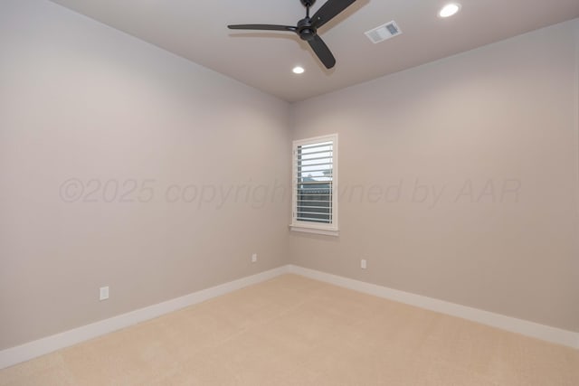 spare room featuring visible vents, baseboards, recessed lighting, light colored carpet, and a ceiling fan