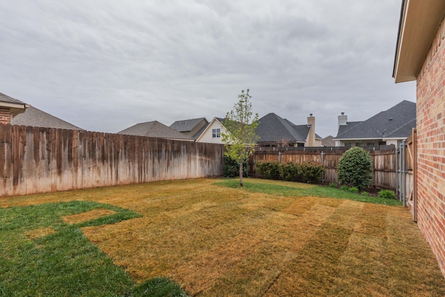 view of yard with a fenced backyard