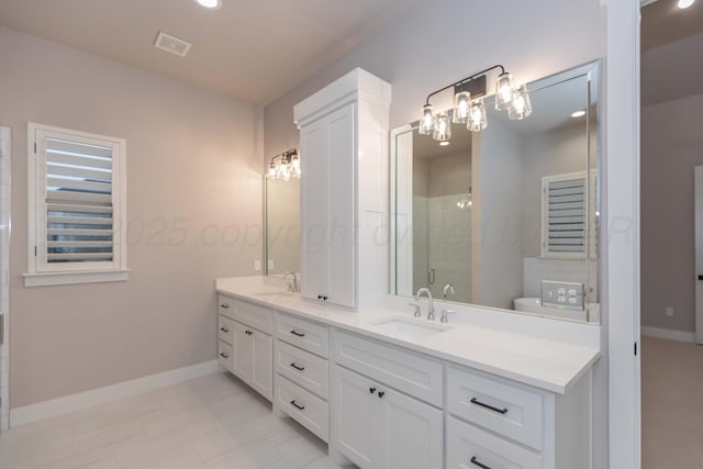 bathroom featuring visible vents, double vanity, baseboards, a sink, and a stall shower