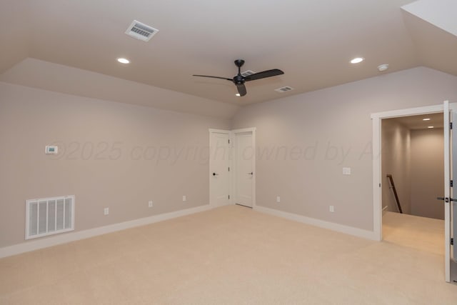empty room featuring recessed lighting, visible vents, and vaulted ceiling
