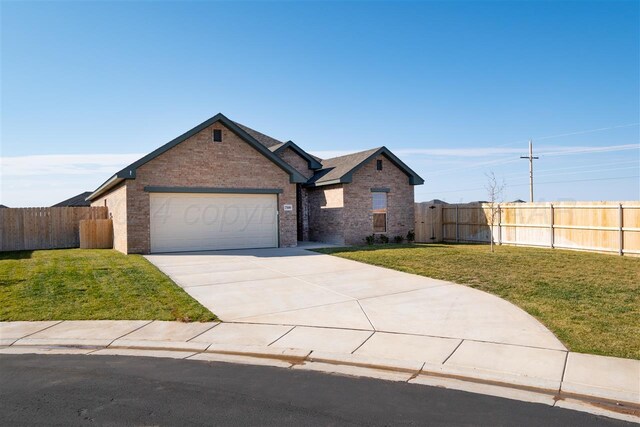 view of front facade with a garage and a front lawn