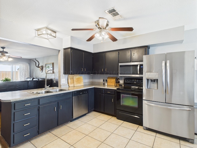 1409 Bailey Ave, Dumas, TX 79029 - kitchen featuring appliances with stainless steel finishes, ceiling fan, a peninsula, and light countertops