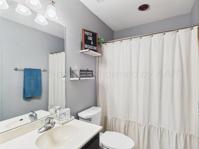 1409 Bailey Ave, Dumas, TX 79029 - full bathroom featuring vanity, a textured wall, and a textured ceiling