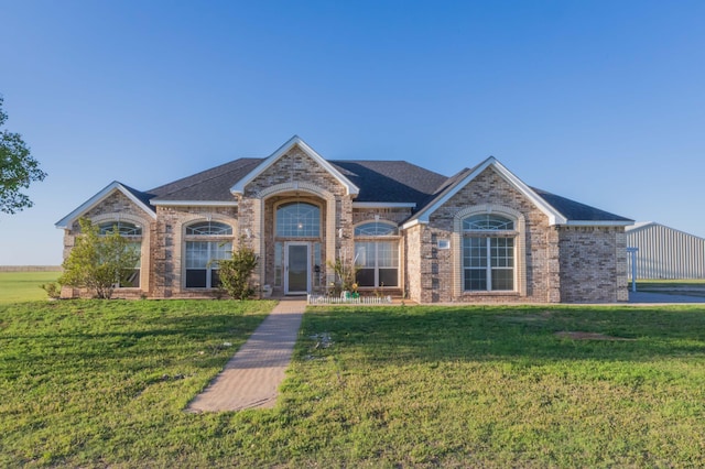 view of front of house with brick siding and a front yard