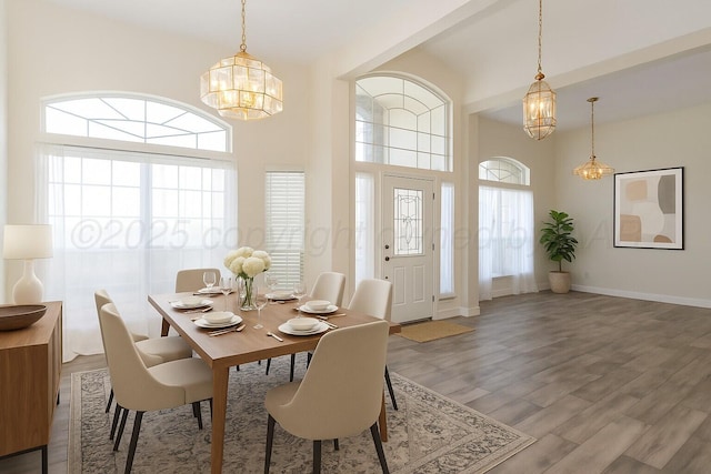 dining room featuring baseboards, a notable chandelier, and wood finished floors