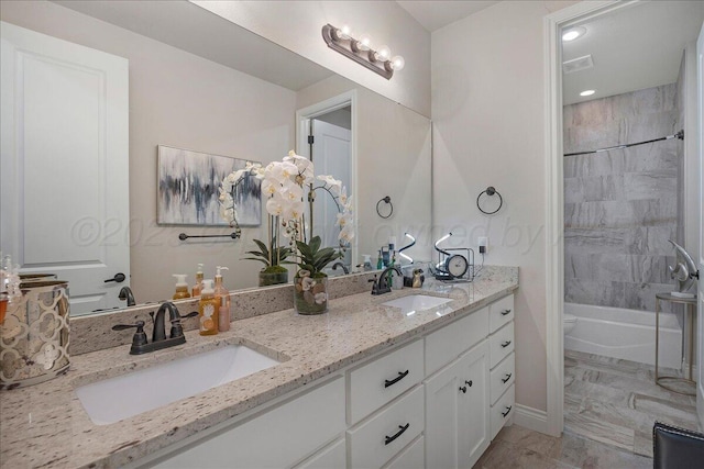 9109 Staten Island St, Amarillo, TX 79119 - bathroom with double vanity, shower / washtub combination, marble look tiles, and recessed lighting
