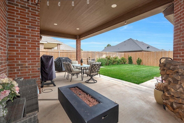9109 Staten Island St, Amarillo, TX 79119 - fenced backyard featuring an outdoor fire pit, a patio area, area for grilling, and outdoor dining area