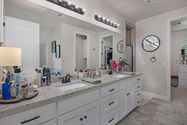 9109 Staten Island St, Amarillo, TX 79119 - bathroom with double vanity and baseboards