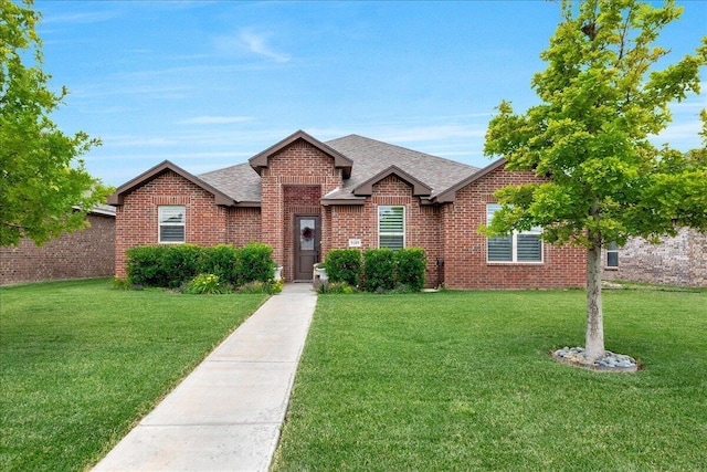 9109 Staten Island St, Amarillo, TX 79119 - view of front facade with a shingled roof, brick siding, and a front lawn