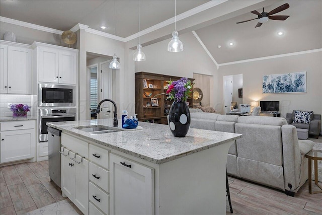 9109 Staten Island St, Amarillo, TX 79119 - kitchen featuring stainless steel appliances, an island with sink, a ceiling fan, light wood-style flooring, and lofted ceiling