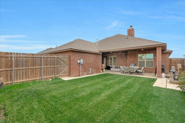 9109 Staten Island St, Amarillo, TX 79119 - back of house featuring brick siding, a patio area, roof with shingles, a fenced backyard, and a chimney