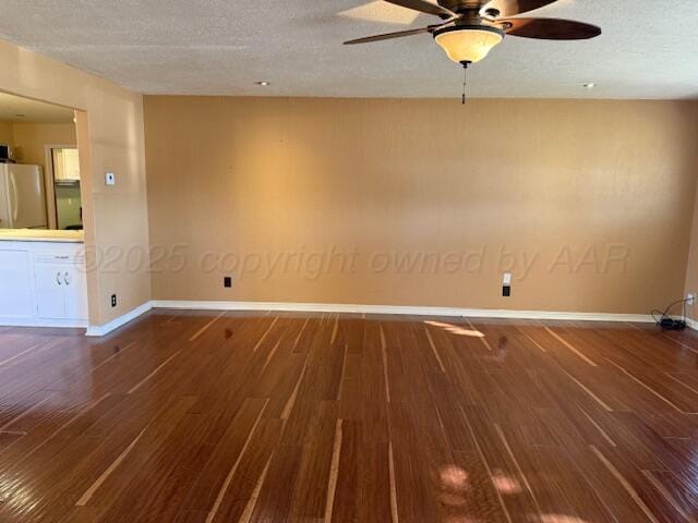 unfurnished room featuring wood finished floors, baseboards, a textured ceiling, and a ceiling fan