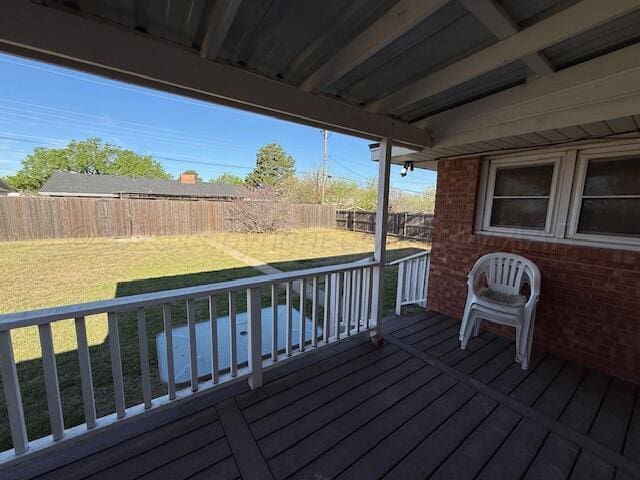 deck with a fenced backyard and a lawn