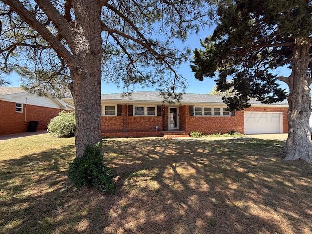 ranch-style house featuring an attached garage, entry steps, and brick siding
