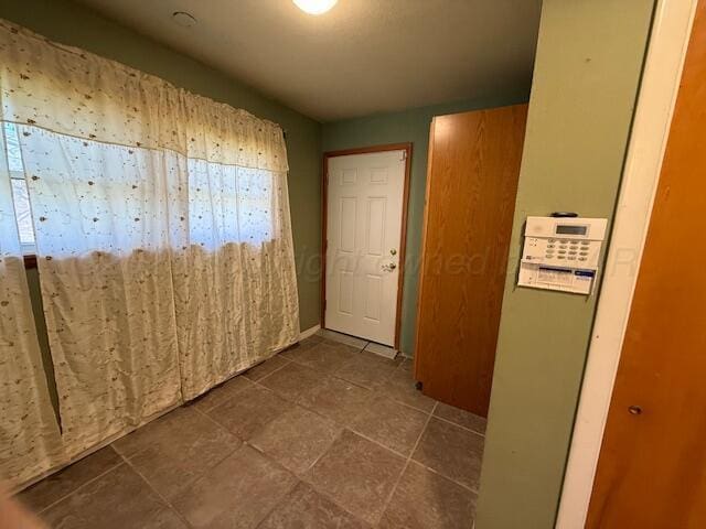 hallway with dark tile patterned floors