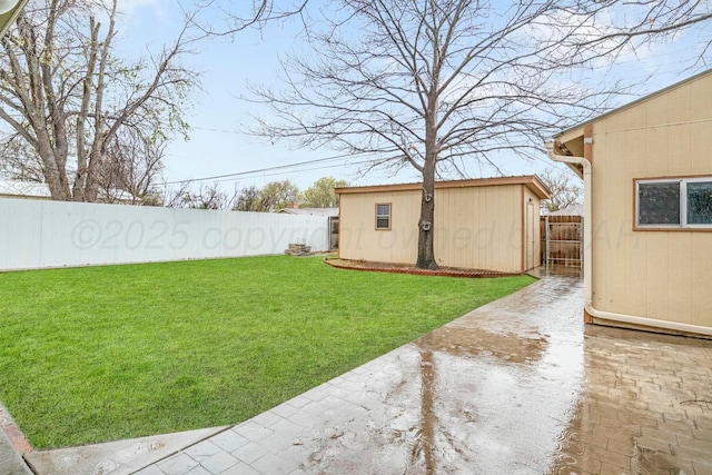 view of yard with a fenced backyard and an outbuilding