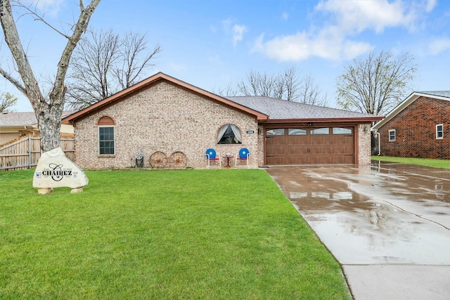 view of front facade with concrete driveway, fence, an attached garage, a front yard, and brick siding