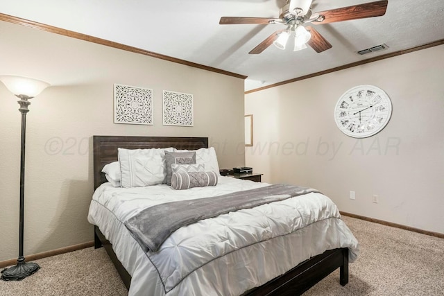 bedroom featuring baseboards, visible vents, crown molding, and carpet floors
