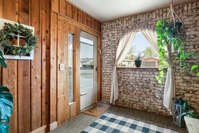 entryway with wooden walls