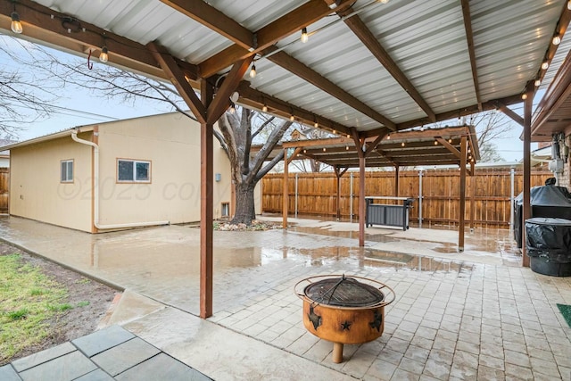 view of patio / terrace featuring an outdoor fire pit and a fenced backyard