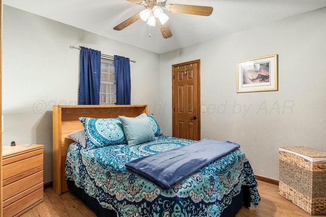 bedroom with baseboards, wood finished floors, and a ceiling fan