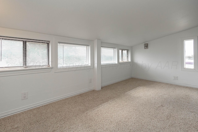 1107 Yucca Ave, Amarillo, TX 79108 - spare room with lofted ceiling, baseboards, and carpet