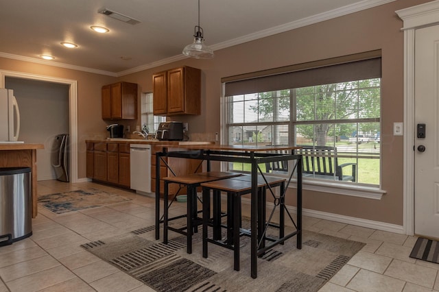 1107 Yucca Ave, Amarillo, TX 79108 - kitchen featuring ornamental molding, plenty of natural light, light tile patterned floors, dishwasher, and baseboards