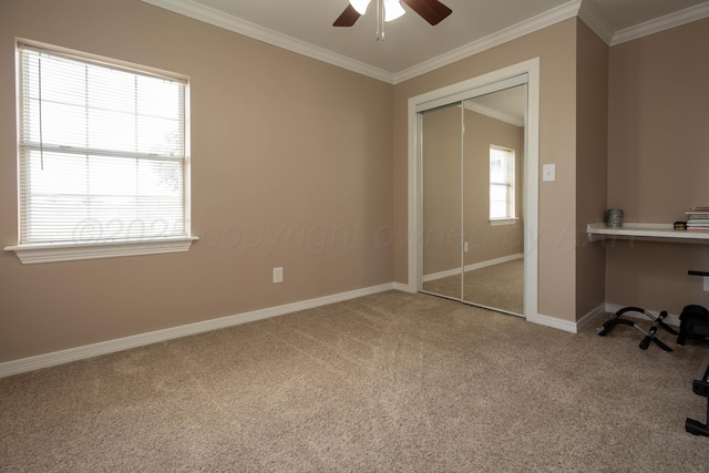 1107 Yucca Ave, Amarillo, TX 79108 - unfurnished bedroom featuring carpet, a closet, crown molding, baseboards, and ceiling fan
