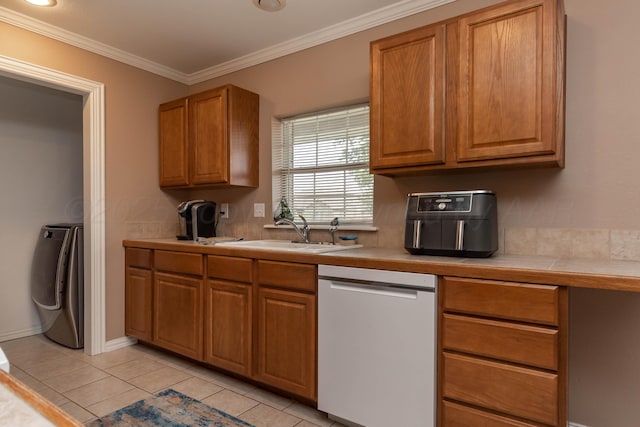 1107 Yucca Ave, Amarillo, TX 79108 - kitchen featuring white dishwasher, a sink, washer / clothes dryer, tile counters, and light tile patterned floors