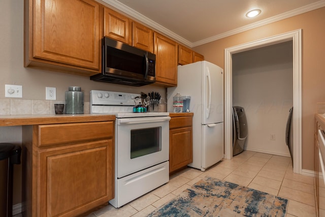 1107 Yucca Ave, Amarillo, TX 79108 - kitchen featuring white appliances, washing machine and dryer, ornamental molding, light countertops, and brown cabinets