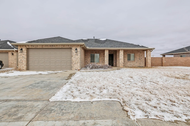 view of front of property featuring an attached garage, roof with shingles, concrete driveway, and brick siding