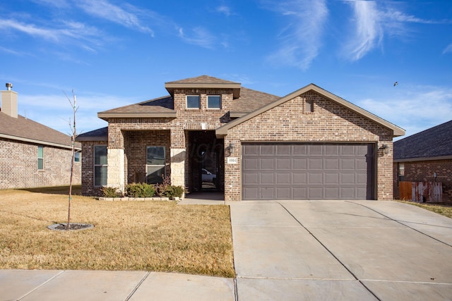 view of front of property featuring a garage and a front yard