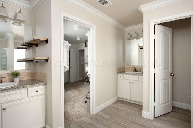 bathroom featuring vanity, crown molding, and wood-type flooring