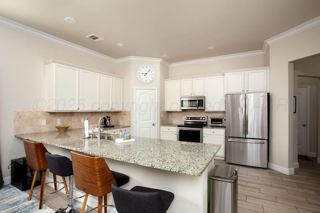 kitchen featuring sink, white cabinetry, light stone counters, kitchen peninsula, and stainless steel appliances