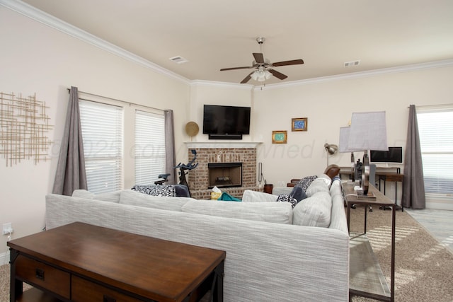 living room with crown molding, a fireplace, light hardwood / wood-style floors, and ceiling fan