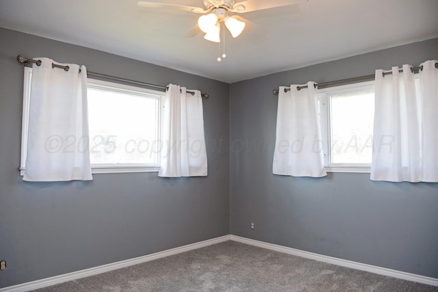 1215 S Main St, Hereford, TX 79045 - carpeted empty room featuring plenty of natural light, ceiling fan, and baseboards