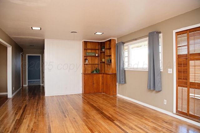 1215 S Main St, Hereford, TX 79045 - empty room with wood finished floors and baseboards