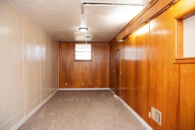 1215 S Main St, Hereford, TX 79045 - empty room featuring carpet floors, wooden walls, and crown molding