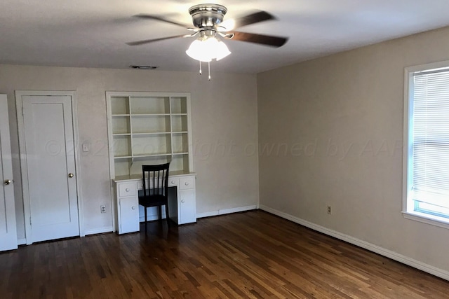 1000 S Bryan St, Amarillo, TX 79102 - unfurnished office with a ceiling fan, dark wood-type flooring, and baseboards