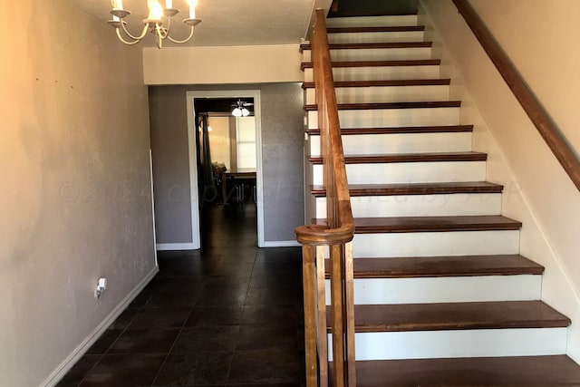 1000 S Bryan St, Amarillo, TX 79102 - stairway with tile patterned flooring, a chandelier, and baseboards