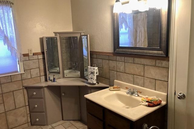 1000 S Bryan St, Amarillo, TX 79102 - bathroom featuring tile walls, vanity, and wainscoting